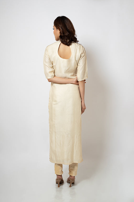 Off white brocade suit with golden beads hand embroidered around neckline